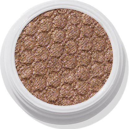 ColourPop So Quiche Super Shock Shadow, a metallic olive‑taupe eyeshadow with pink and gold sparkle, catching light in its bouncy, dimpled pan inside a white twist pot, shown in a clean close-up on a white background.