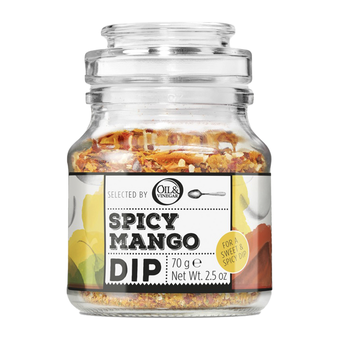 A glass jar containing Spicy Mango Dip with visible pieces of mango, chili, and herbs inside.