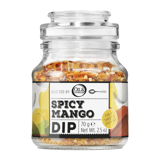 A glass jar containing Spicy Mango Dip with visible pieces of mango, chili, and herbs inside.