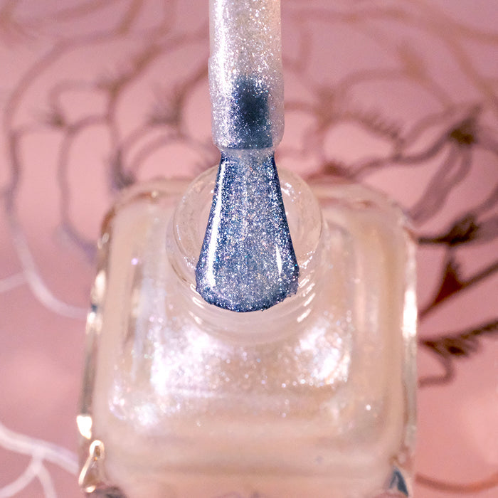 Top-angled, close-up of opened Kiss Nail Lacquer bottle with the brush showing. Emphasizes glitter particles.