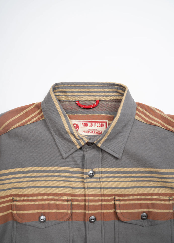Gray and brown striped button-up shirt with dual chest pockets, featuring an Iron and Resin label, displayed on a white background.