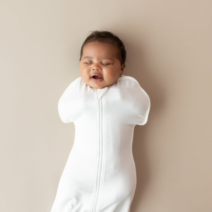 Close up of baby yawning wearing Swaddle Bag in Cloud 0.5
