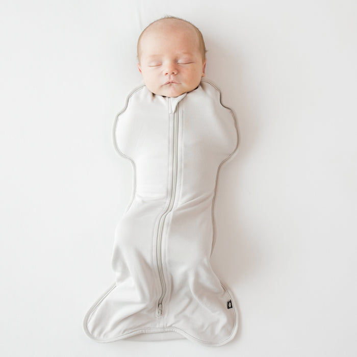 Baby sleeping in Kyte Baby Swaddle Bag in Oat 0.5