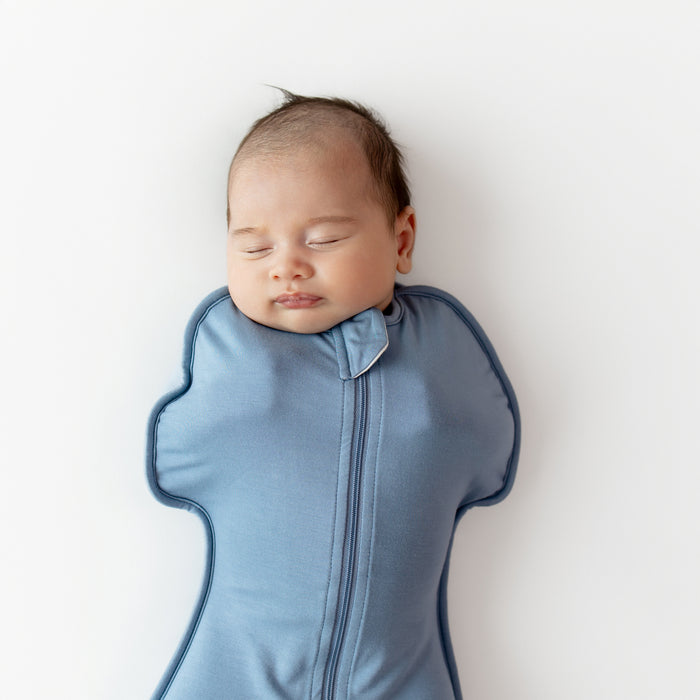 Close up of baby wearing Kyte Baby Swaddle Bag 0.5 in Slate