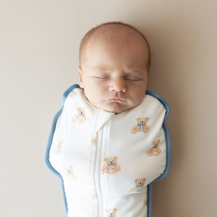 Close up on baby sleeping in Kyte Baby Swaddle Bag in Teddy Bear 0.5