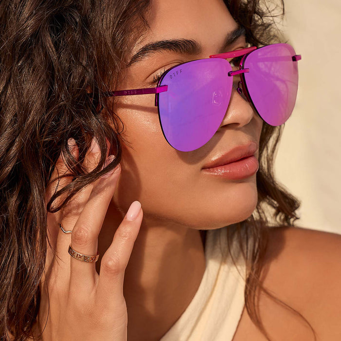 lifestyle - female wearing diff eyewear tahoe aviator sunglasses with a pink rush metallic frame and pink rush mirror lenses front view