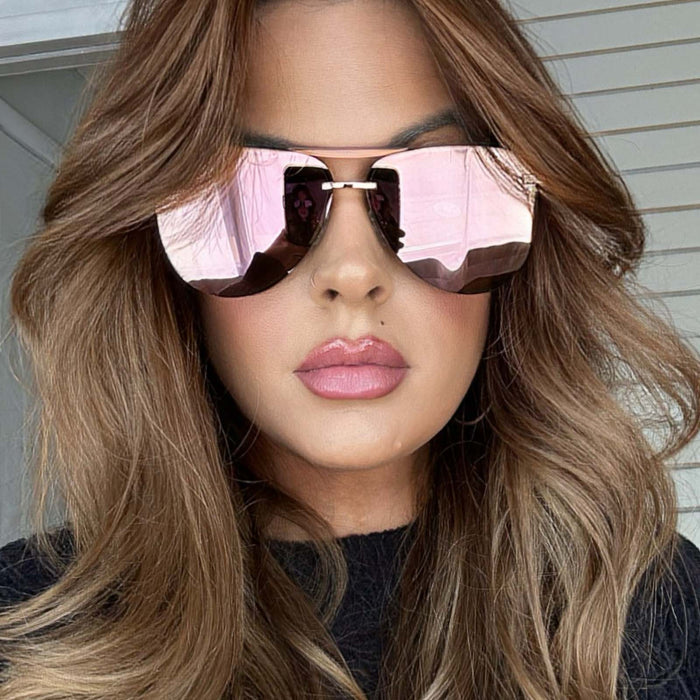 lifestyle - musicmellie wearing diff eyewear tahoe aviator sunglasses with a rose gold metal frame and cherry blossom mirror lenses front view