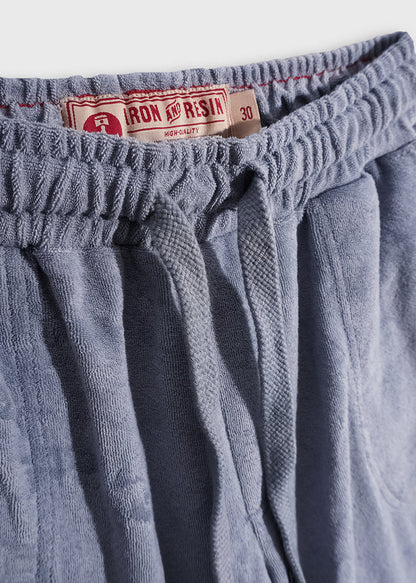 Blue drawstring shorts with an Iron and Resin label, size 30, featuring a textured fabric and elastic waistband.