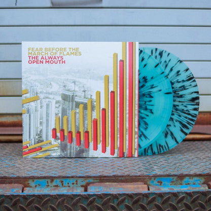 A photo of the vinyl with both LP's peaking out of the jacket. The record is leaned up against a metal warehouse gate.