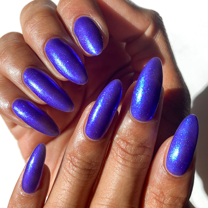 Close-up of nails painted with Tiara Nail Lacquer on medium skin tone.