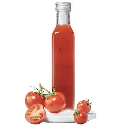 A tall, slender bottle of tomato pulp vinegar, with fresh tomatoes displayed in front.