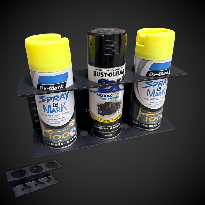 Collection of spray paint cans on a black stand with a dark background