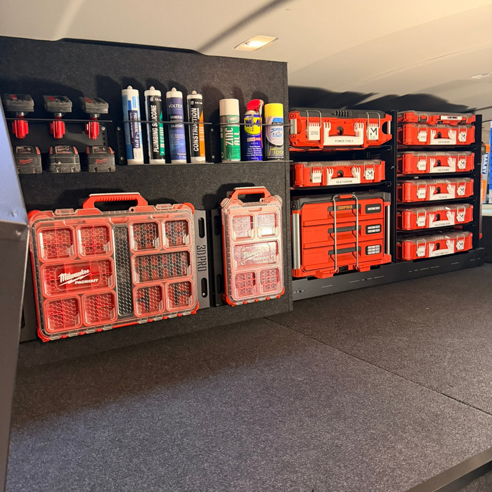 Storage area with red toolboxes and supplies on a gray false floor.