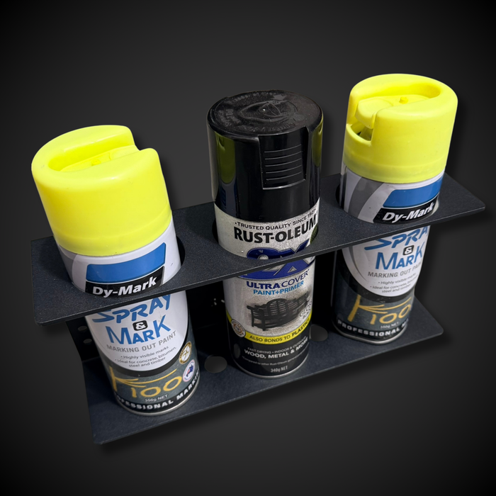 Collection of spray paint cans on a black stand against a dark background