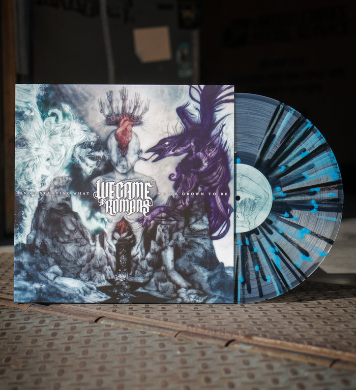 A Clear W/ Black & Blue Splatter vinyl from We Came As Romans is partially pulled from its cover, which displays fantasy art of a deer, white lion, and purple wolf on a mystical, cloudy background.