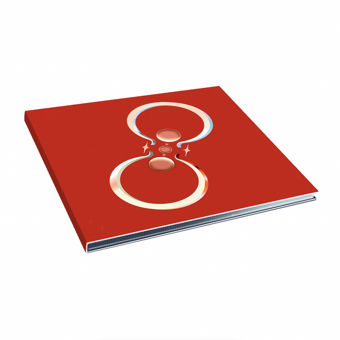 A red CD showcases two silver/gold rings facing each other with sparkles around them.
