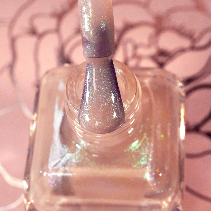 Top-angled, close-up of opened Venus Nail Lacquer bottle with the brush showing. Emphasizes glitter particles.