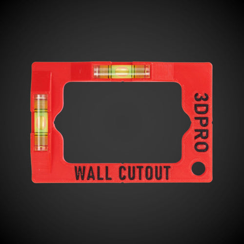 A red and black wall cut out template tool with horizontal and vertical spirit levels, and space to attach with a carabiner.