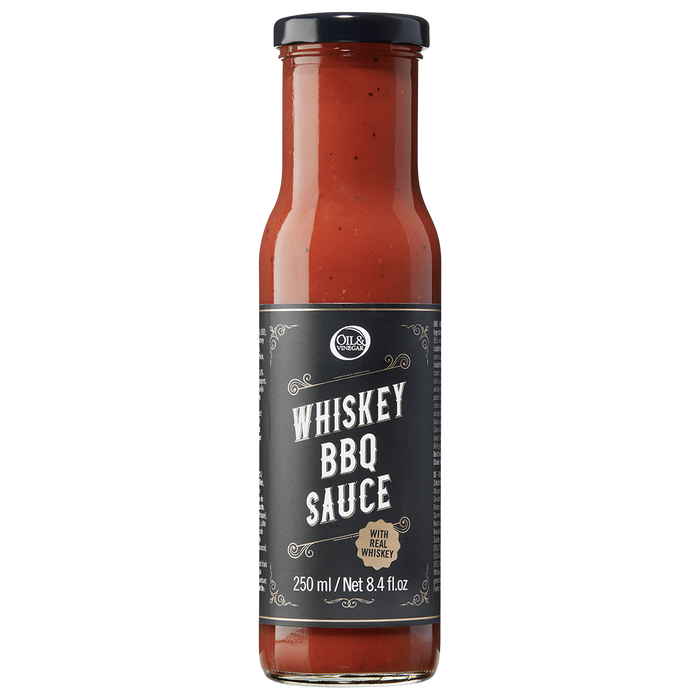 A bottle of Whiskey BBQ Sauce with a label showing the product name and volume.