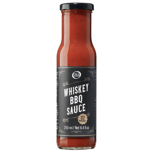 A bottle of Whiskey BBQ Sauce with a label showing the product name and volume.