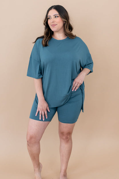 Female looking off to the side with one hand on hip wearing the Women’s Biker Short Set in Atlantic