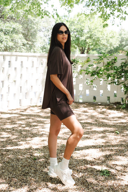 Female posing showing the side view of the Women’s Biker Short Set in Espresso