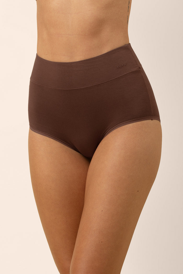 Brown high-waisted underwear worn by a woman on a beige background