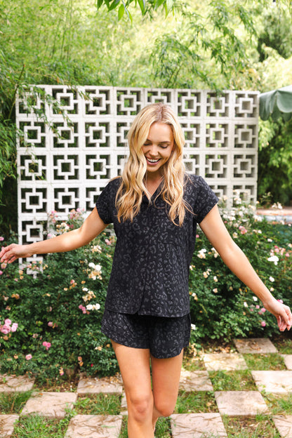 Female walking outside wearing the Women’s Short Sleeve Pajama Set in Midnight Leopard